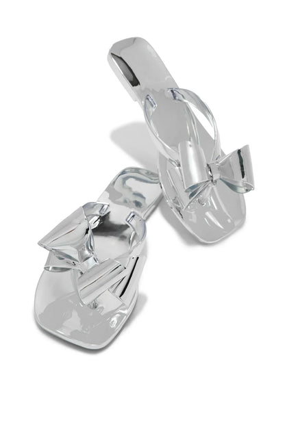 Lyla silver metallic open-toe slide sandals with square toe and decorative bow detail