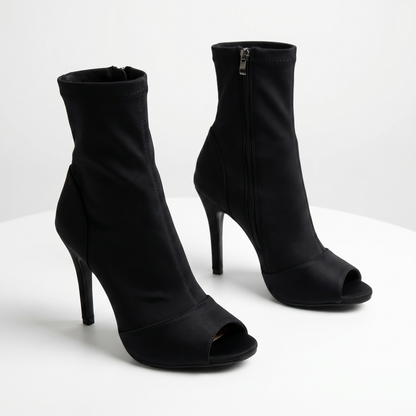 Black high-heeled open-toe ankle boots on a white background