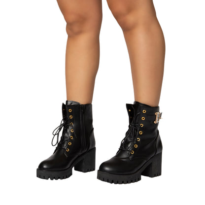 Black leather lace-up ankle boots with chunky heels and gold eyelets, sleek silhouette by Justina
